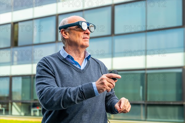 Aged man using futuristic augmented mixed vision headset outdoors
