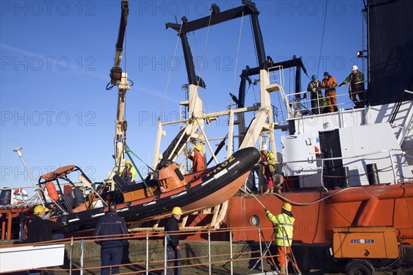 Men loading offshore supply vessel Putford Achilles, Great Yarmouth