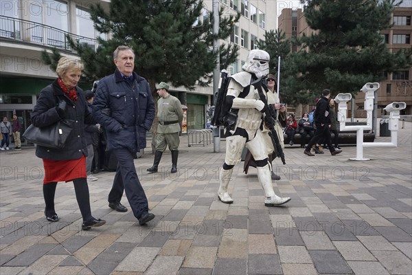 People walk past carnies in Star Wars costumes on a shopping street in Liverpool, 02/03/2019