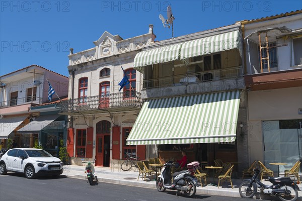 Traditional buildings on a sunny street with parked cars and motorbikes, Museum of Silk Art, Soufli, Eastern Macedonia and Thrace, Greece, Europe