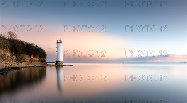 The Maltzien lighthouse stands at the foot of a small cliff at the southern tip of the Zudar peninsula on the island of Ruegen