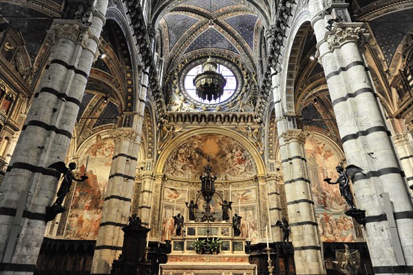 Black and white striped marble columns in the cathedral, cross and round arches, Siena, Tuscany, Italy, Europe