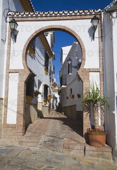 Moorish archway architectural feature and alleyway in the Andalusian village of Comares, Malaga province, Spain, Europe