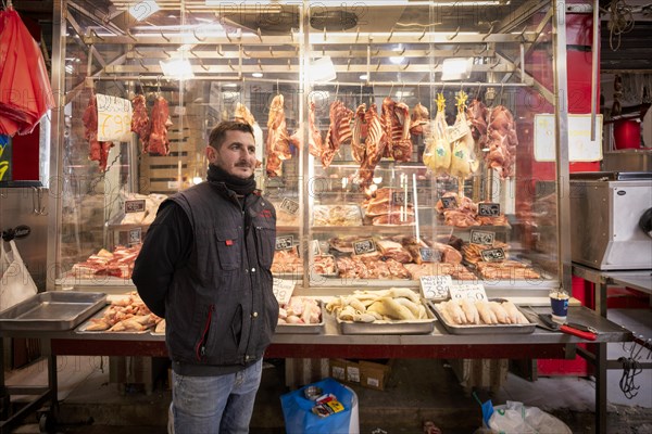 Butcher, meat trader posing proudly in front of his market stall, display of fresh meat, butchery, food, Kapani market, Vlali, Thessaloniki, Macedonia, Greece, Europe