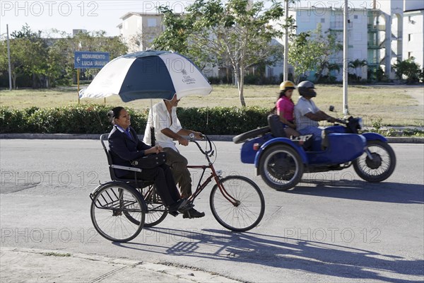 Bicycle and motorbike on the road near Holguin, Cuba, Central America