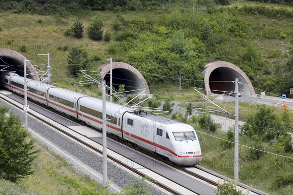 Two tunnels for cars on the A71 motorway, next to a tunnel into which an ICE1 train enters. The new Leipzig Erfurt line is a high-speed railway line between Erfurt and Nuremberg, Behringen, 19.06.2018