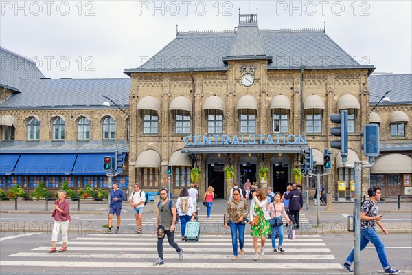 Railway station in Gothenburg with people crossing a city street at the pedestrian crossing, Gothenburg, Sweden, Europe
