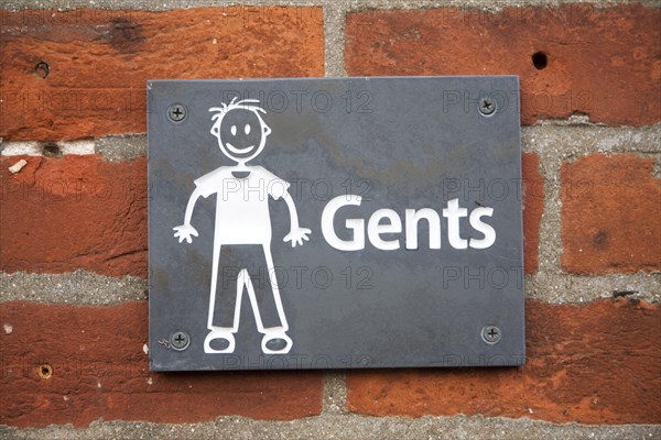 Drawing sign white figure on black slate for Gents toilets, UK