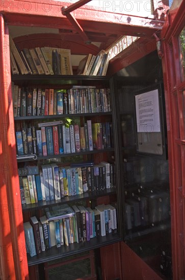 Old red telephone box used for book exchange, Suffolk, England, United Kingdom, Europe