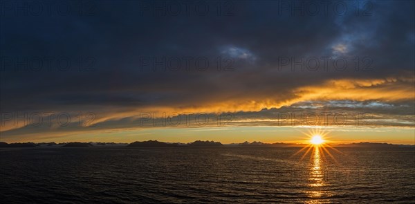 Sun setting on a rainy evening over Isfjorden, Isfjord in summer at sunset, Spitsbergen, Svalbard, Norway, Europe