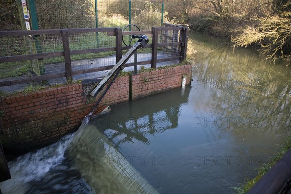 Whitebridge weir on the River Deben, Campsea Ashe, Suffolk England is a simple mechanical device to regulate river flow between the seasons