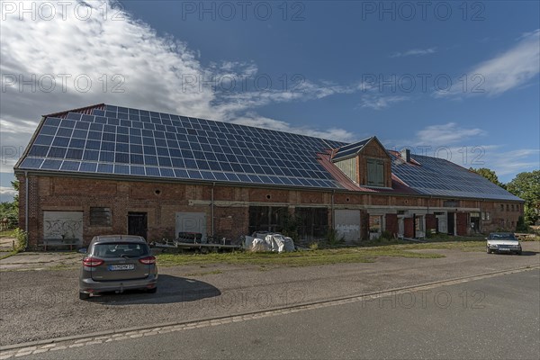 Photovoltaics on the roof of an old, empty barn, Plueschow, Mecklenburg-Vorpommern, Germany, Europe