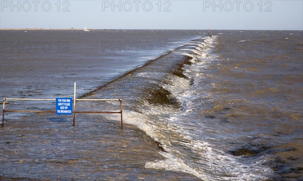 High seas forcing waves over the harbour mouth breakwater at Harwich, Essex, England, United Kingdom, Europe