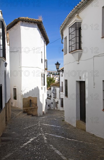Historic street cobbled street architecture in old city Ronda, Spain, Europe