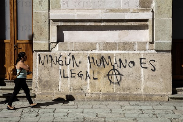 Oaxaca, Mexico, Graffiti on a wall reads No Human is Illegal. Many migrants are making their way through southern Mexico, attempting to reach the United States, Central America