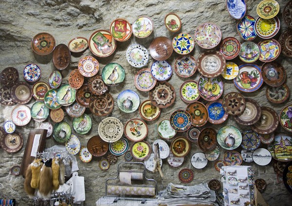 Ceramic plates on display on wall of cave shop Setenil de las Bodegas, Cadiz province, Spain, Europe