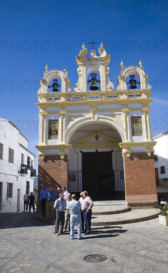 Men gather by the baroque church of San Juan at Zahara de la Sierra, Spain Sunday 13 October 2013 after the National Day holiday