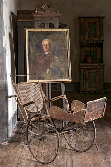 Portrait of Ernst Casimir Count of Ysenburg and Buedingen, painting on easel, old Thonet wheelchair around 1900, junk, knight's castle from the Middle Ages, Ronneburg Castle, Ronneburg hill country, Main-Kinzig district, Hesse, Germany, Europe