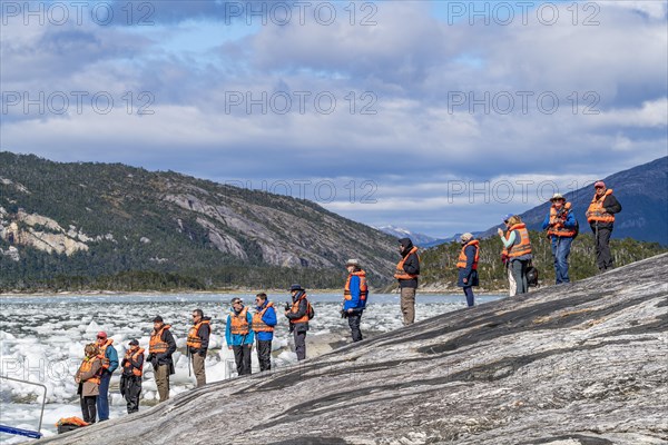 Passengers of the cruise ship Stella Australis waiting in line for a rubber dinghy at Pia Glacier, Alberto de Agostini National Park, Avenue of Glaciers, Chilean Arctic, Patagonia, Chile, South America