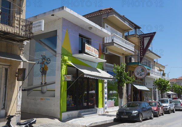 Modern building with a colourful facade and parked vehicles on the roadside, commercial street, Soufli, Eastern Macedonia and Thrace, Greece, Europe