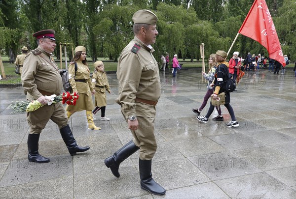 Men in Russian uniforms walk to the Russian memorial in Treptower Park in Berlin on the 74th anniversary of the victory of Russia over Germany, 09.05.2019