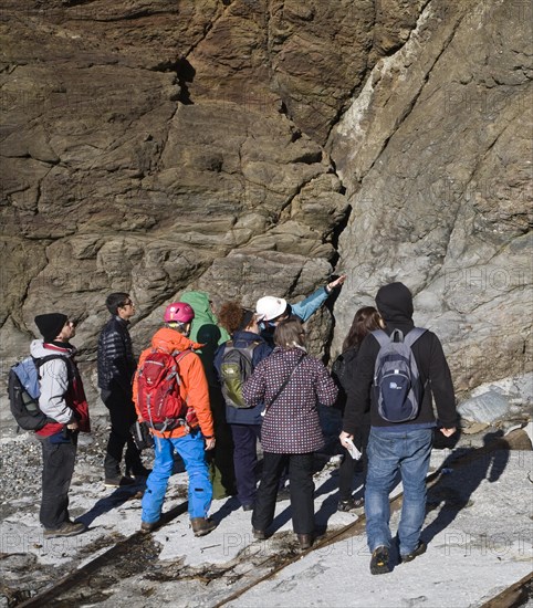 Student group of geologists on a fieldtrip at Polpeor Cove, Lizard Point, Cornwall, England, United Kingdom, Europe