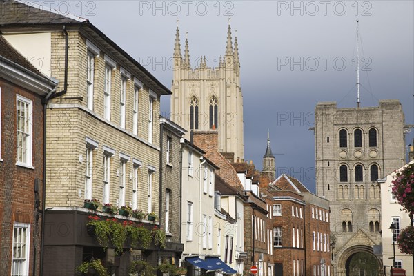 Tower of Saint Edmundsbury Cathedral above a street of historic buildings, Bury St Edmunds, Suffolk, England, United Kingdom, Europe