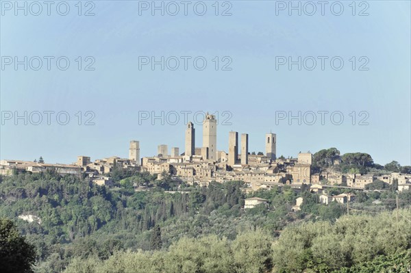 Town view, town scape, cityscape of San Gimignano in autumn, gender towers, countryside, in fall, fields of olive trees, wineyards, Tuscany, Italy, Europe