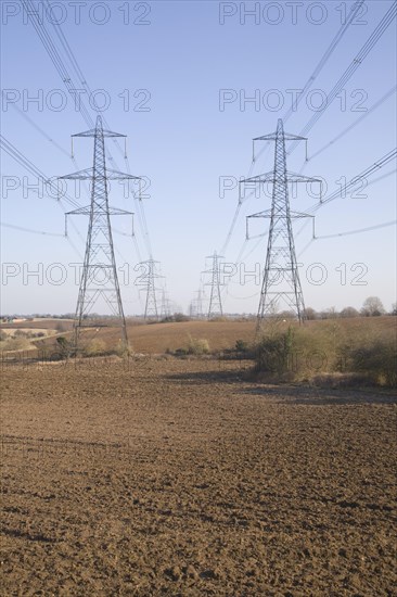 Electricity pylons and transmission lines cross countryside, Claydon, Suffolk, England, United Kingdom, Europe