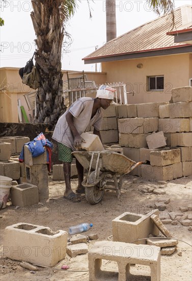Young man working on a construction site in Nigeria, 06/02/2024