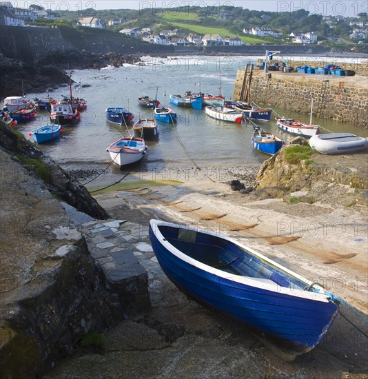 Small fishing boats in the harbour at the village of Coverack on the Lizard peninsula, Cornwall, England, United Kingdom, Europe