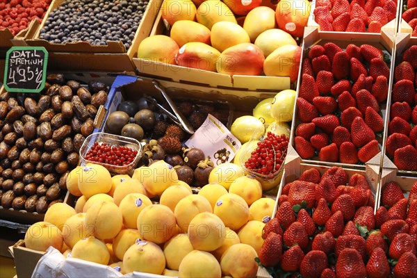 Fresh strawberries, mangoes, dates, peaches, blueberries and redcurrants at the fruit and vegetable market in Malaga, 12/02/2019