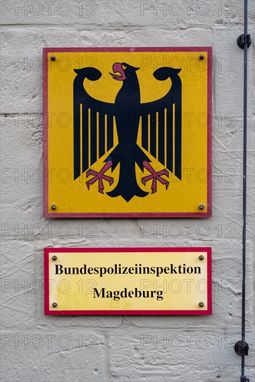 Yellow and red sign with Federal Police Inspectorate and an eagle on the wall of a building, Magdeburg, Saxony-Anhalt, Germany, Europe