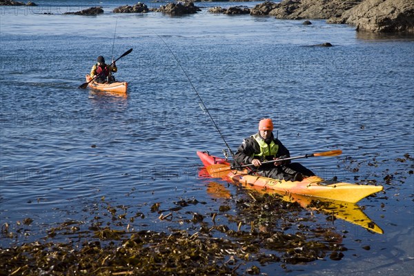 Two men fishing from kayak canoes off Lizard Point, Cornwall, England, United Kingdom, Europe