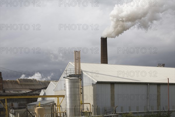 Steam rising from chimneys as sugar beet is processed at the British Sugar factory, Bury St Edmunds, Suffolk, England, United Kingdom, Europe