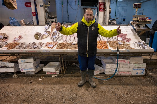 Trader, fishmonger posing proudly in front of his market stall, display of fresh fish and seafood on ice, Food, Kapani Market, Vlali, Thessaloniki, Macedonia, Greece, Europe