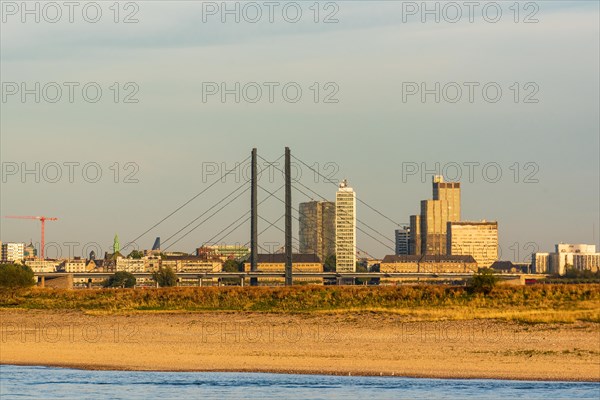 Cityscape at sunset with modern bridge and skyscrapers in the background, Duesseldorf, North Rhine-Westphalia
