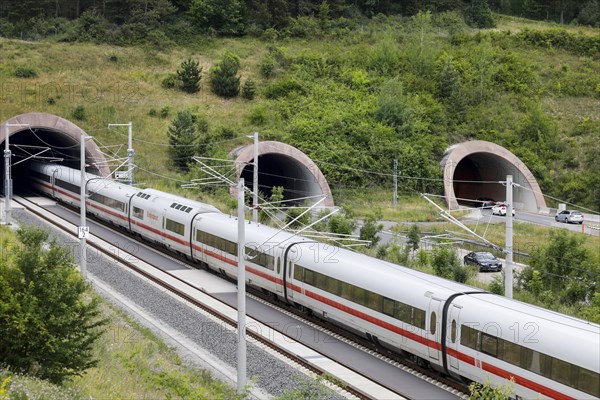 Two tunnels for cars on the A71 motorway, next to a tunnel into which an ICE1 train enters. The new Leipzig Erfurt line is a high-speed railway line between Erfurt and Nuremberg, Behringen, 19.06.2018