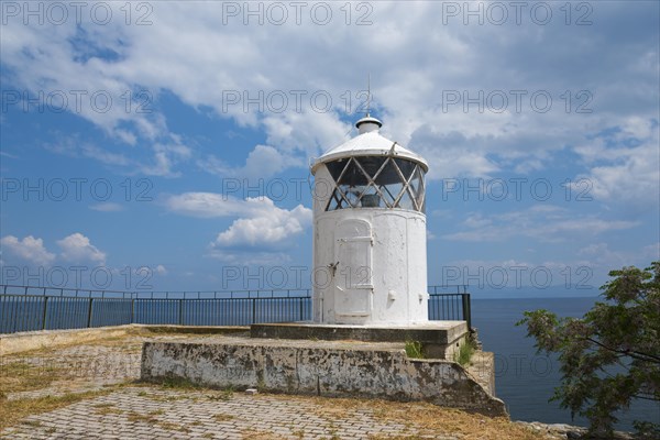 White lighthouse at the edge of a coast with cloudy sky in the background, old town, Kavala, Dimos Kavalas, Eastern Macedonia and Thrace, Gulf of Thasos, Gulf of Kavala, Thracian Sea, Greece, Europe