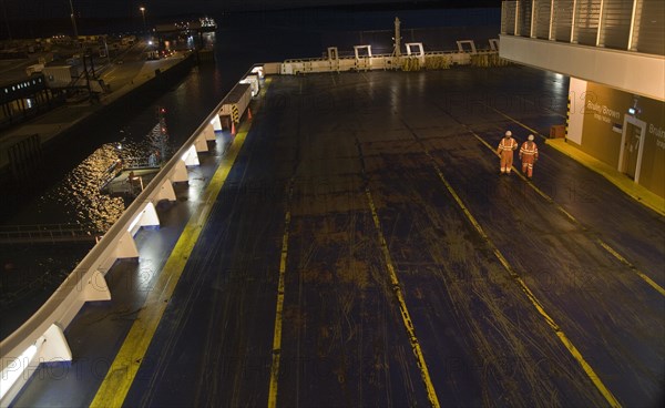 Two seaman walking on cargo deck of Stena night ferry, Harwich, Essex, England, United Kingdom, Europe