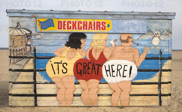 Painted deckchair hire shed with traditional seaside picture of people in swimming costumes, Great Yarmouth, Norfolk, England saying: 'It's Great Here!'