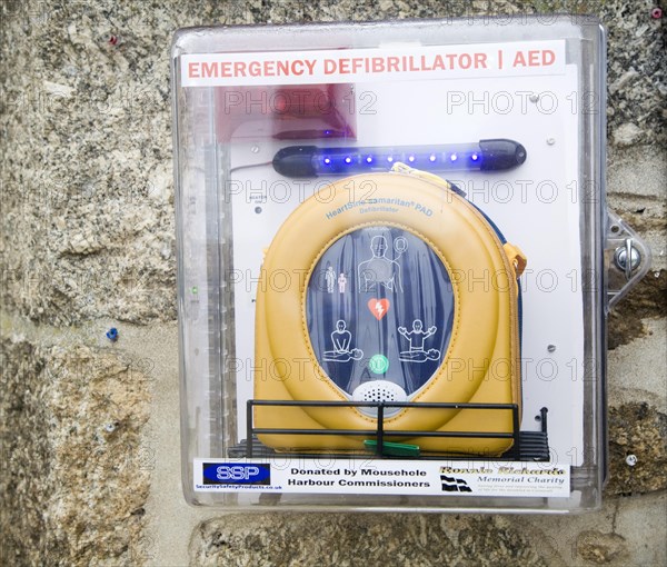Emergency Defibrillator for public emergency use mounted on a wall, Mousehole, Cornwall, England, United Kingdom, Europe