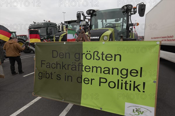 Sign on the subject of shortage of skilled labour on a tractor, farmers' protests, demonstration against the policies of the traffic light government, abolition of agricultural diesel subsidies, Duesseldorf, North Rhine-Westphalia, Germany, Europe