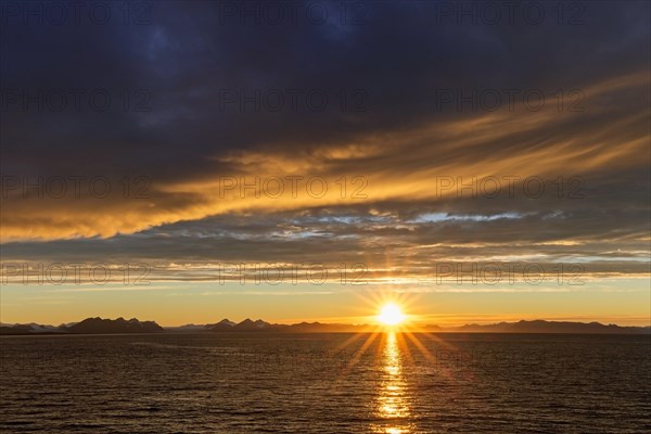 Sun setting on a rainy evening over Isfjorden, Isfjord in summer at sunset, Spitsbergen, Svalbard, Norway, Europe