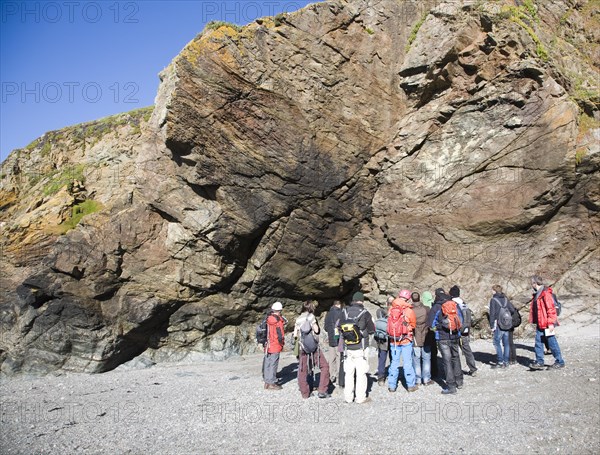 Student group of geologists on a fieldtrip at Polpeor Cove, Lizard Point, Cornwall, England, United Kingdom, Europe