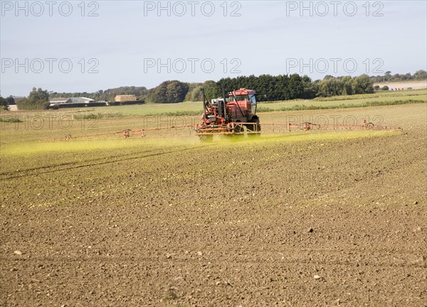 Farm machinery spraying Glyphosate herbicide on an arable field near Hollesley, Suffolk, England, United Kingdom, Europe