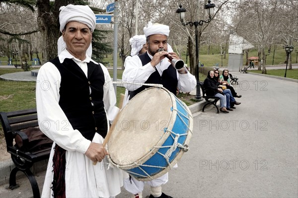 Musicians in traditional dress play music in a park in Tehran, Iran, woman, 14.03.2019, Asia