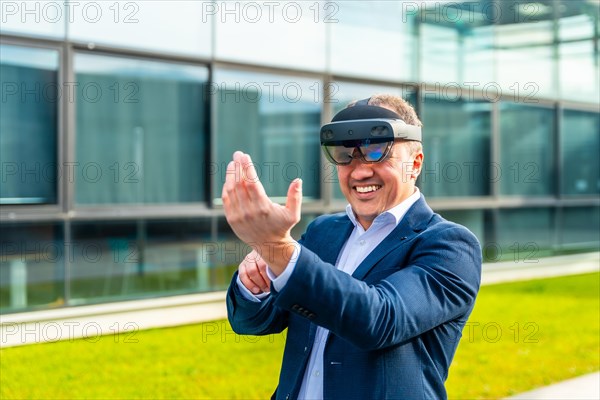 Happy adult caucasian businessman smiling while wearing mixed reality glasses outside a financial building