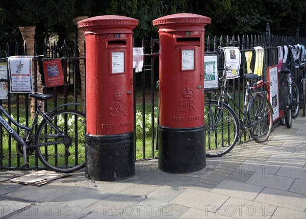 Two old traditional red pillar boxes in the street, Cambridge, England, United Kingdom, Europe