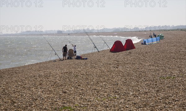 People sea fishing from beach, Hollesley Bay, Shingle Street, Suffolk, England, United Kingdom, Europe